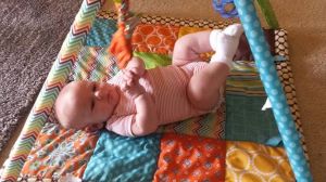 Each day gets better playing on his play mat. 