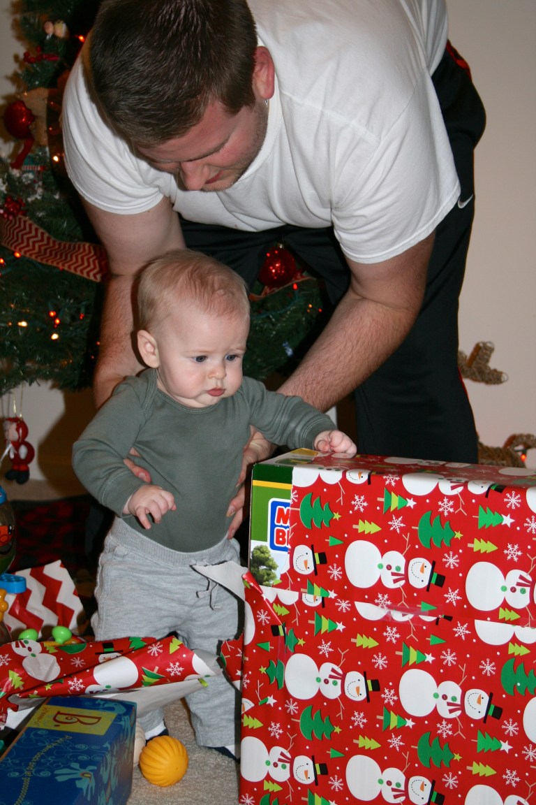 Daddy helping Grayson open his gifts from Santa.
